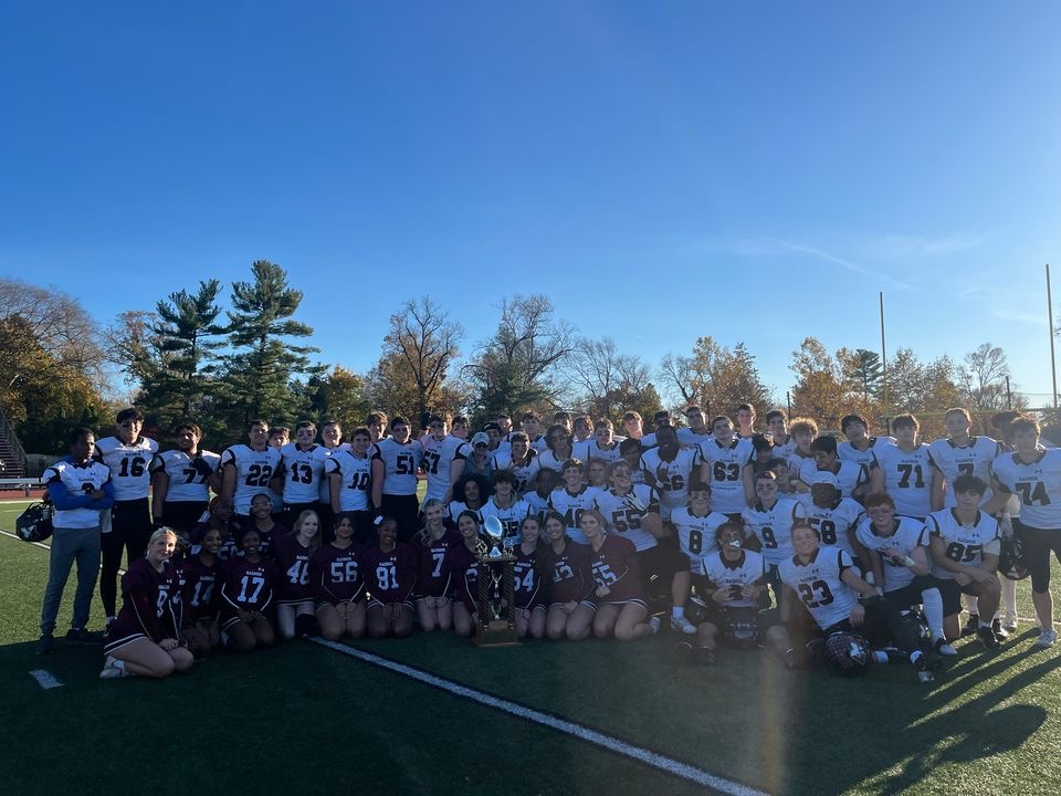 Football team and cheerleaders with trophy. Taken by Stevie Laverty